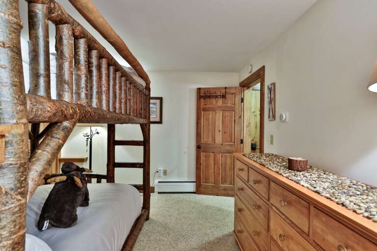 A long dresser and closet mean the bunk-room crew can unpack and keep the floor clear.