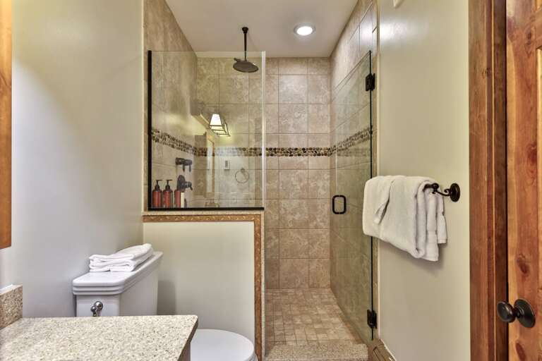 Start the morning beneath the rain-style shower, with a built-in bench close by.