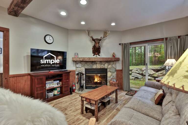Tend the fire from the sofa, then open the patio door when the Vermont air feels too good to miss.