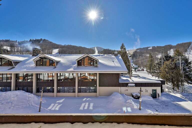The balcony faces the ski trails across the neighboring rooftops.