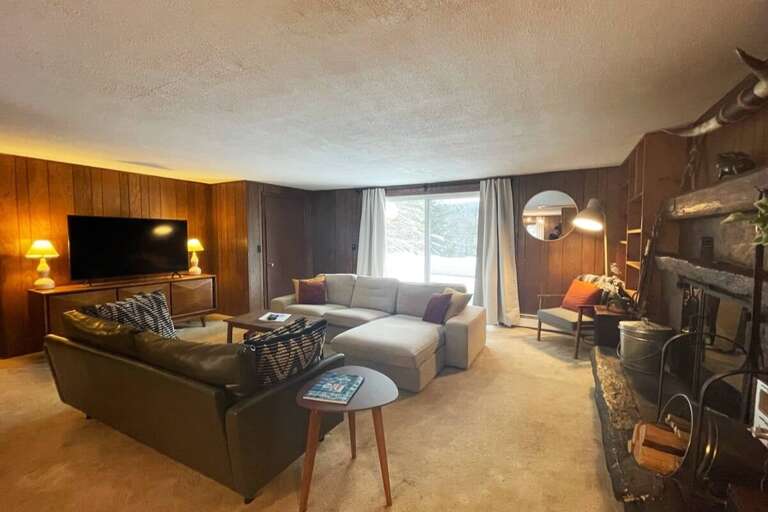 The living room opens onto the deck, so the group can spend time together indoors and out.