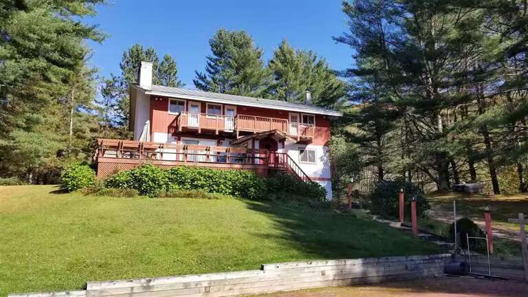 The private yard stretches out below the deck, with space to enjoy time outside. It is not fully fenced.