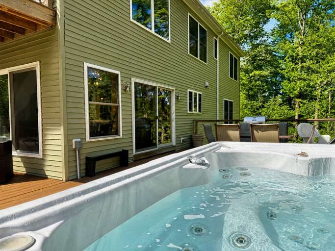 Enjoy the private deck hot tub beside the woods. Included late December through mid March; an optional $195 setup fee applies at other times.