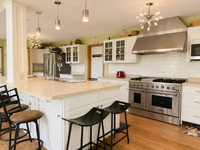Use the two ovens for different dishes while friends take a seat at the island.