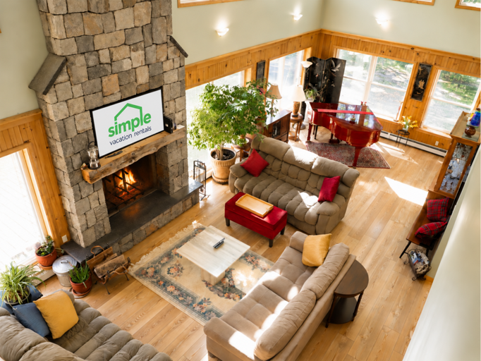 This overhead view shows how the seating area opens toward the baby grand piano and the windows beyond.