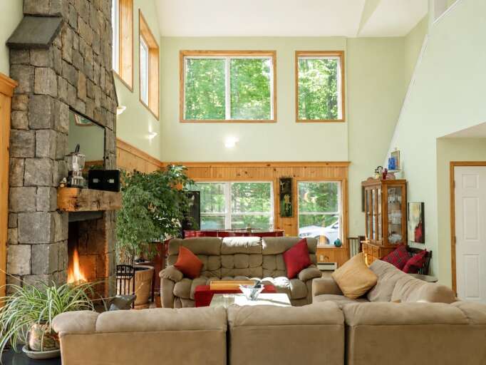 The great room has several sofas beneath the high windows, with room to sit together after a day out.