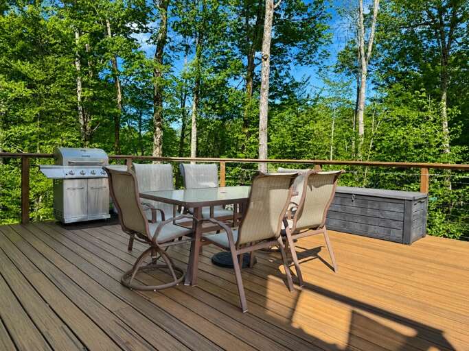 Put dinner on the grill and eat at the deck table, with trees just beyond the railing.