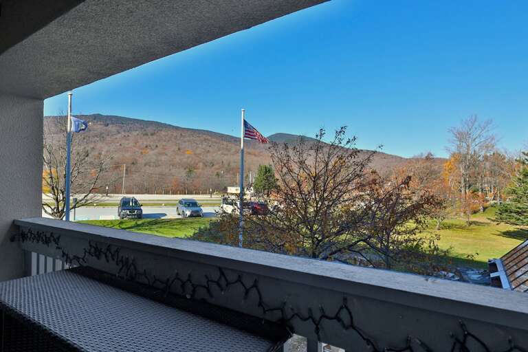 Look across the resort grounds toward the wooded mountain from your balcony.