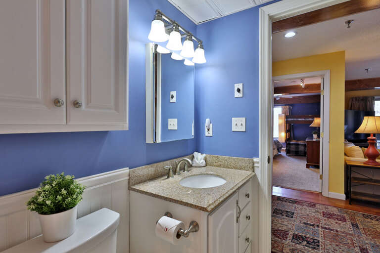 The vanity and nearby cabinets give toiletries a place of their own.