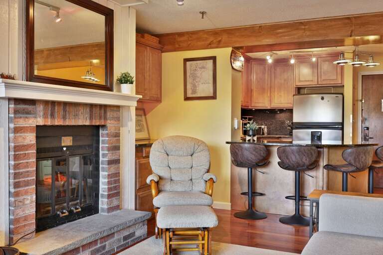 A rocker by the fireplace is only a few steps from the breakfast counter.