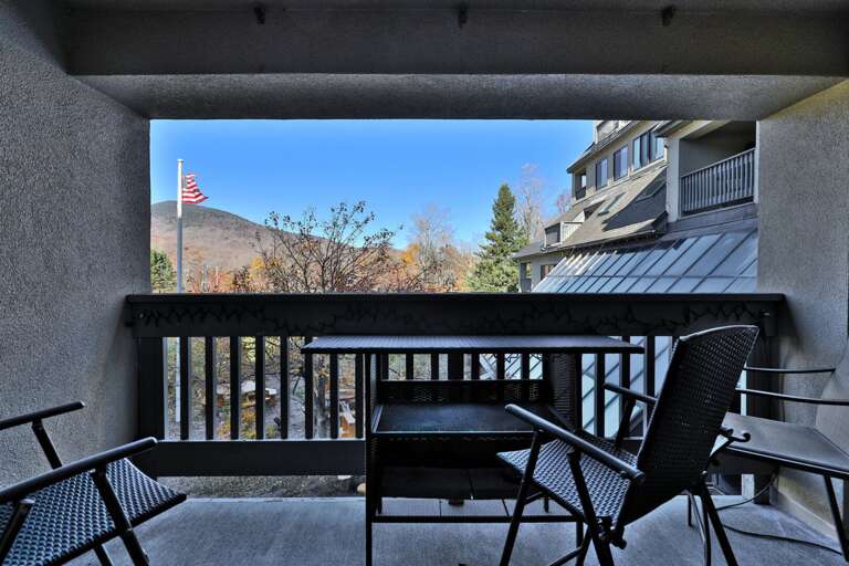 Bring your coffee onto the covered balcony for a look toward the wooded ridge.