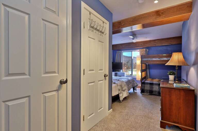 The short entry leads into the bedroom, with the bed and bunks beyond.