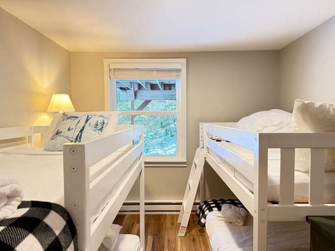 This entry-level bedroom has two twin-over-twin bunk beds, giving four guests their own sleeping spots.