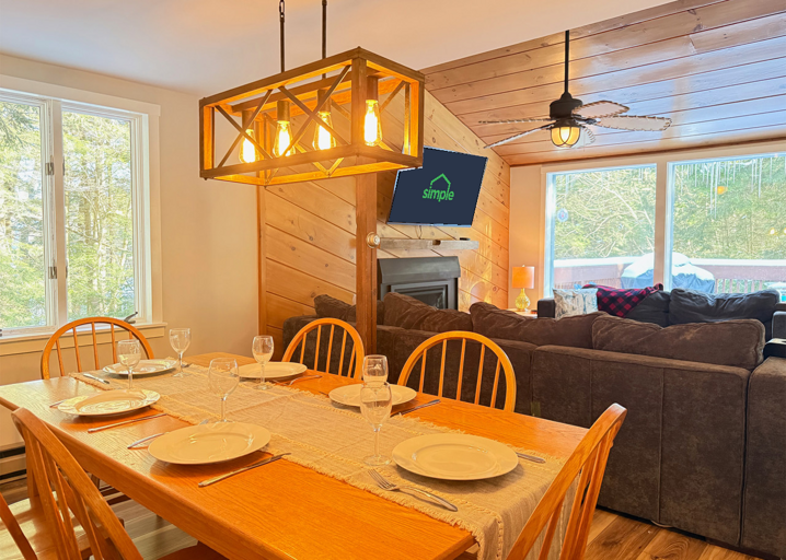 Share a meal at the dining table while the rest of the group settles into the sofas just beyond it.