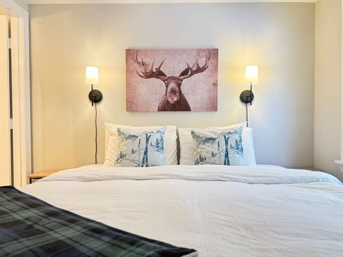 The primary bedroom has a king bed and an attached bathroom, on the same entry level as the other bedrooms.