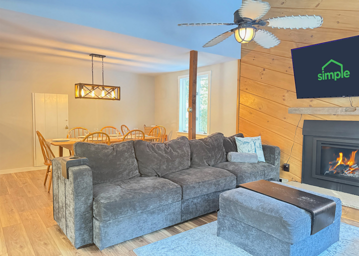The dining table sits just behind the living-room seating, so dinner and an evening on the sofa share one open space.