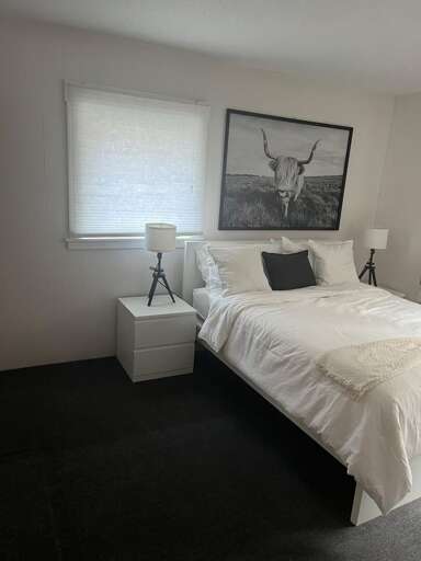 A window beside the bed brings natural light into this single-queen room.