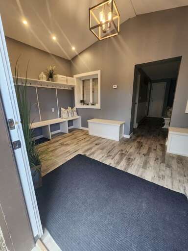 The entrance opens into the mudroom, with storage along the wall.