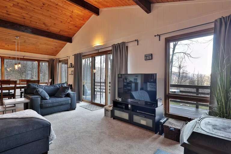 Sliding doors connect the living area with the raised deck.