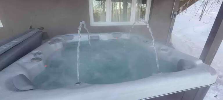 The tub has molded seats and jets beneath the deck. Included late December through mid-March; off-season setup is $195. Arrange before arrival.