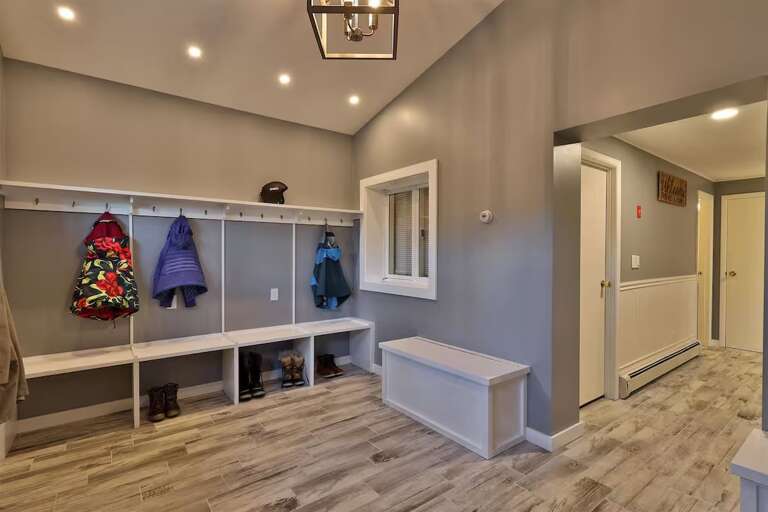 Hooks, cubbies, and a long bench make a useful first stop with winter gear.