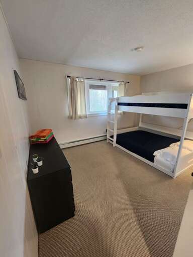 Bedroom one has a queen-over-queen bunk bed, with a ladder to the upper bed.