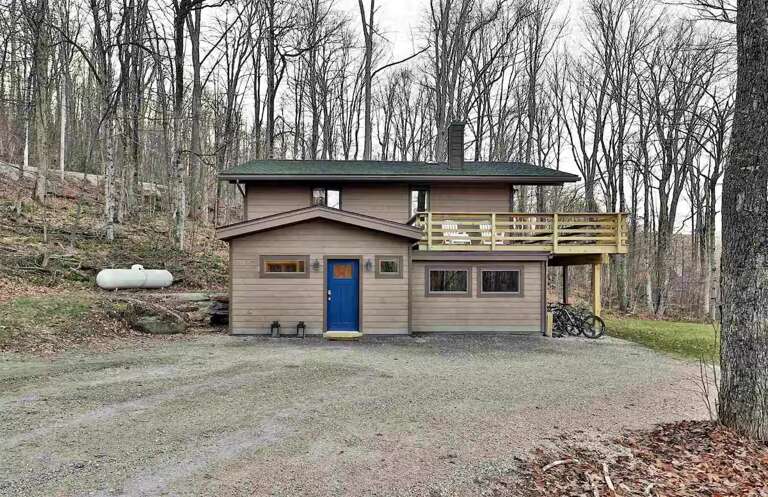 This view shows the entrance and gravel parking area for arrival.