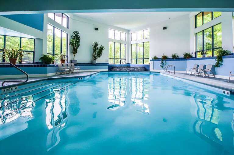 The shared indoor pool has tall windows and poolside seating. Check the Sports Center's seasonal schedule for your stay.