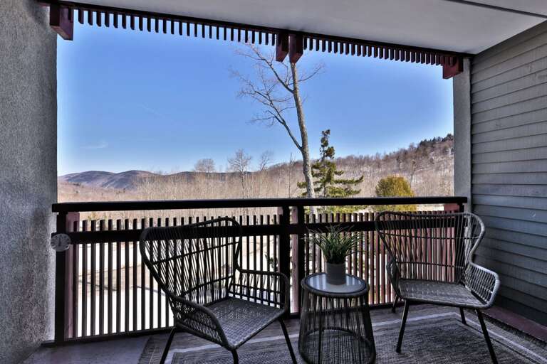 Take your coffee to the covered balcony and look out toward the wooded ridges.