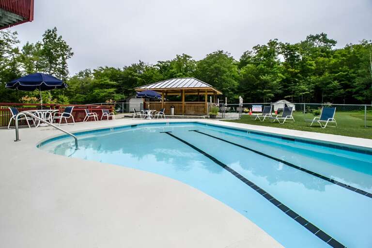 The shared outdoor pool has tables and a pavilion for a break between swims when the pool is open.