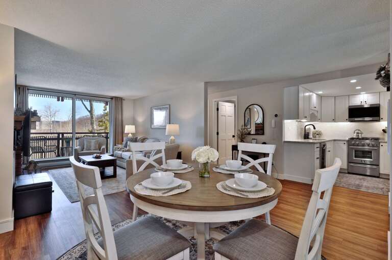Bring dinner from the kitchen to the round table, with the lounge and balcony just beyond.