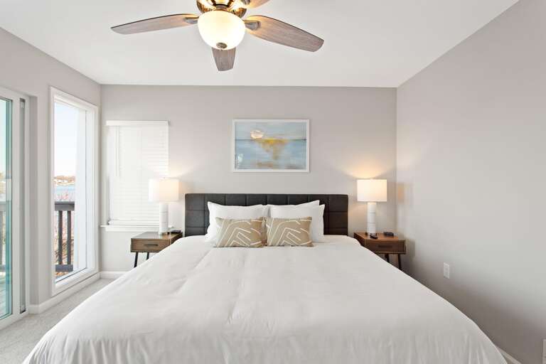 Modern Bedroom With Large Bed, Nightstands, And Artwork Modern Bedroom With Large Bed, Nightstands, And Artwork