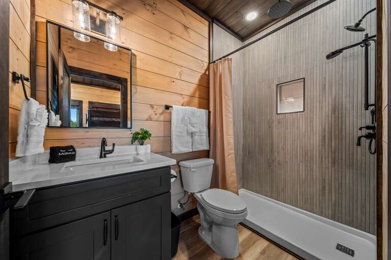 5 full bathrooms + 2 half baths with modern finishes and walk-in showers.