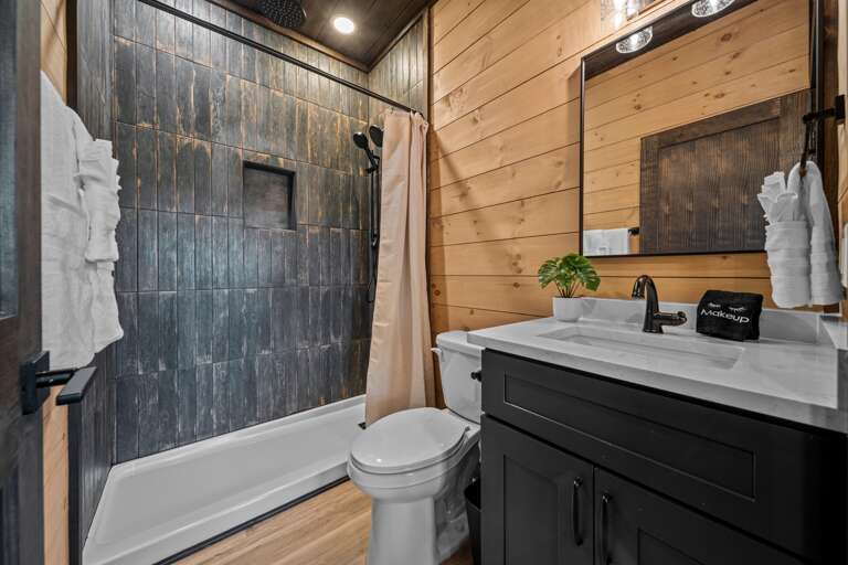 5 full bathrooms + 2 half baths with modern finishes and walk-in showers.