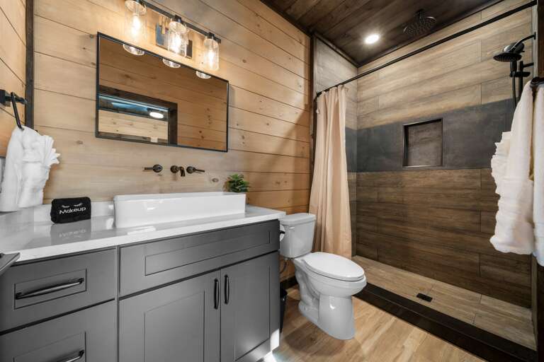5 full bathrooms + 2 half baths with modern finishes and walk-in showers.