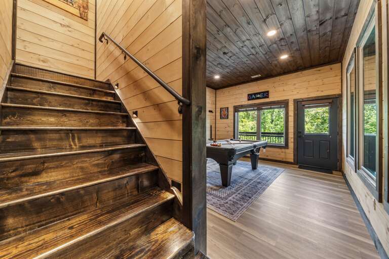 Game room with pool table, arcade machines, and pool view