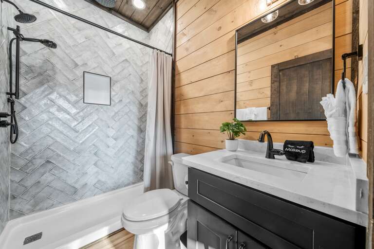 5 full bathrooms + 2 half baths with modern finishes and walk-in showers.