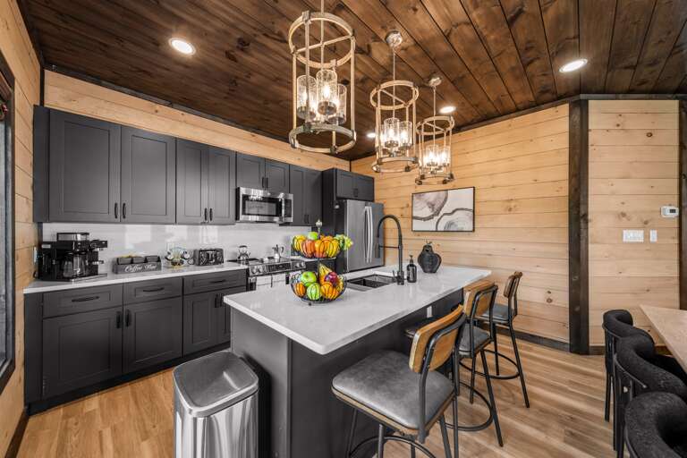 Fully stocked kitchen with stainless appliances and a Ninja coffee station.