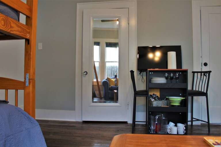 This middle room serves as the kitchenette, living, and dining for the Texas suite. If the Texas suite is rented separately, this is the available area for food, TV, and 2 bunk beds. If the entire house is rented, this is a secondary food and TV area This middle room serves as the kitchenette, living, and dining for the Texas suite. If the Texas suite is rented separately, this is the available area for food, TV, and 2 bunk beds. If the entire house is rented, this is a secondary food and TV area