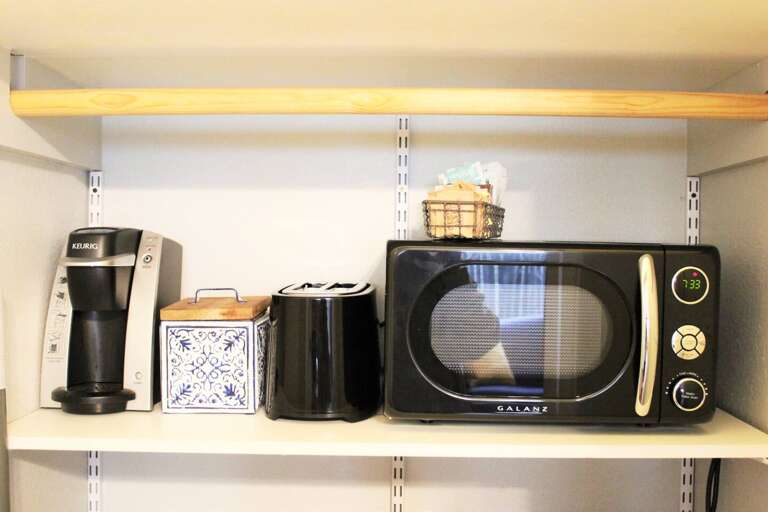 Coffee station in the Texas Suite. This area is part of the kitchenette and includes Keurig, toaster, microwave, electric kettle, mini refrigerator, basic kitchen and dining utensils. Coffee, sugar, sugar substitutes, and creamer provided.  Coffee station in the Texas Suite. This area is part of the kitchenette and includes Keurig, toaster, microwave, electric kettle, mini refrigerator, basic kitchen and dining utensils. Coffee, sugar, sugar substitutes, and creamer provided.