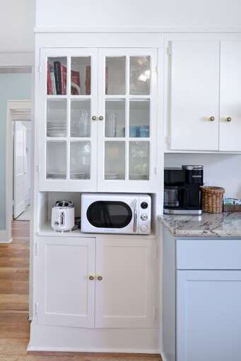 Kitchen Interior With White Cabinetry And Appliances