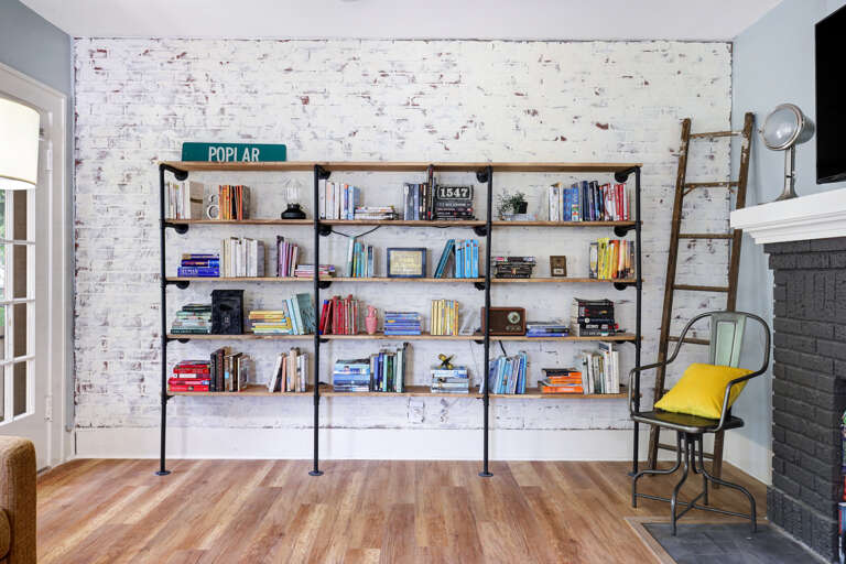 Room Interior With Bookshelf, Chair, And Peeling Wall