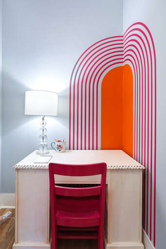 Modern Workspace With Striped Arch Design And Red Chair