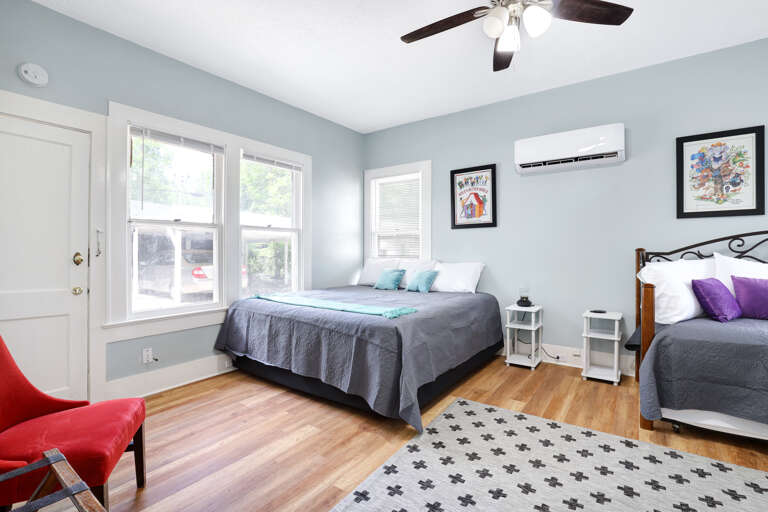Bedroom with king bed and 2 twin beds (one twin with a trundle underneath)