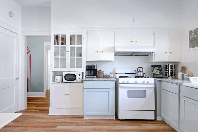 Modern Kitchen Interior With White Cabinets And Appliances