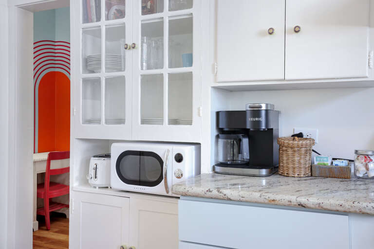 Coffee corner with Keurig, brew pot (if you prefer to bring your own coffee), Keurig pods, creamer, sugar, and a French press in the cabinet