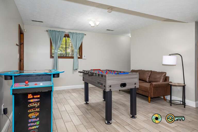 Spacious Game Room In Vacation Rental With Pool Table And Arcade Machine