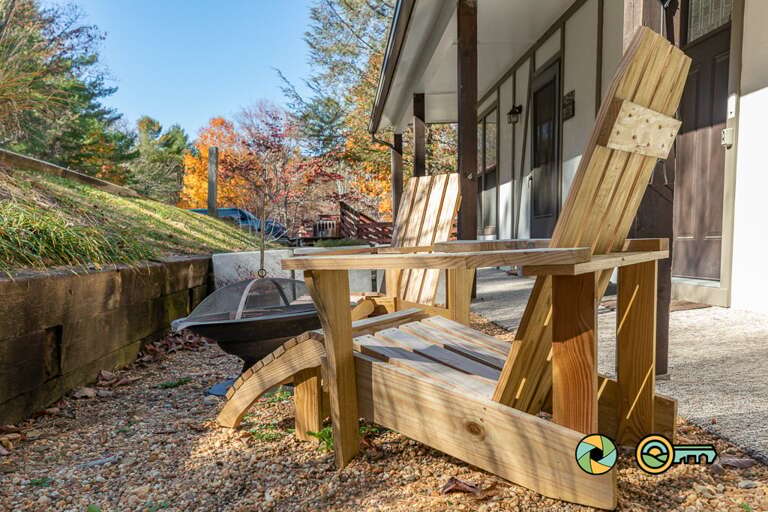 Wooden Chairs On A Patio With Autumn Foliage In The Background Wooden Chairs On A Patio With Autumn Foliage In The Background