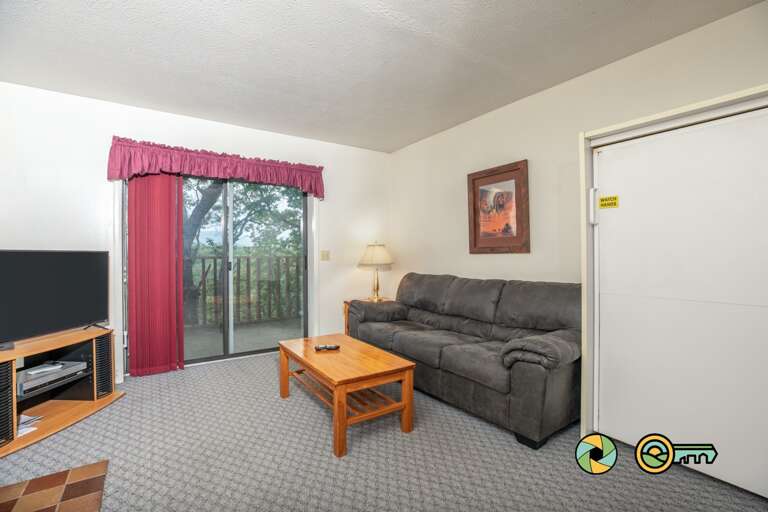 Living Room With Sofa, Table, And Television