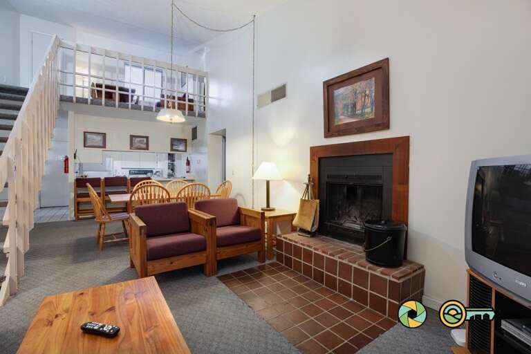 Living Space With Fireplace And Staircase